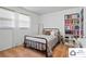 Bedroom featuring an iron bed frame, neutral bedding, and a bookshelf at 707 Hester Dr, Dallas, NC 28034