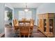 Traditional dining room with a wooden table, chairs, and a large window for natural light at 707 Hester Dr, Dallas, NC 28034