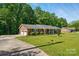 Well-maintained brick home with attached garage, beautiful lawn, and mature trees at 707 Hester Dr, Dallas, NC 28034