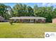 Well-maintained brick home with a green lawn, complemented by neat landscaping and a covered entrance at 707 Hester Dr, Dallas, NC 28034