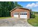 Spacious two-car garage with brick exterior and ample driveway space for parking at 707 Hester Dr, Dallas, NC 28034