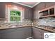 Updated kitchen with granite counters, stainless appliances, and mosaic tile backsplash at 707 Hester Dr, Dallas, NC 28034