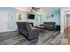 Cozy living room with stone fireplace, ceiling fan, and modern gray sofas and chairs at 707 Hester Dr, Dallas, NC 28034