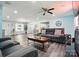 Open-concept living area with modern sofa, ceiling fan, and wood floors; perfect for entertaining at 707 Hester Dr, Dallas, NC 28034