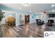 Open-concept living room with hardwood floors, modern lighting, and a comfortable seating area at 707 Hester Dr, Dallas, NC 28034