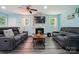 Comfortable living room featuring a stone fireplace, dark wood floors, and modern sofas at 707 Hester Dr, Dallas, NC 28034