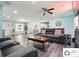 Large living room with hardwood floors, modern furniture, and a ceiling fan for added comfort at 707 Hester Dr, Dallas, NC 28034