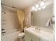 Bathroom featuring a tub with shower, light green vanity and a large mirror at 7138 Wessynton Dr, Charlotte, NC 28226