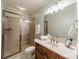 Bathroom with framed glass shower, wood vanity, marble countertop and modern fixtures at 7138 Wessynton Dr, Charlotte, NC 28226