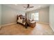 Comfortable bedroom with a four poster bed, ceiling fan, and neutral carpeting at 7138 Wessynton Dr, Charlotte, NC 28226