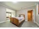 Bedroom with a bench seat next to a window, soft carpet, and a doorway to another room at 7138 Wessynton Dr, Charlotte, NC 28226