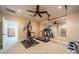 Exercise room with work out machines, neutral carpet, ceiling fan, and large mirror at 7138 Wessynton Dr, Charlotte, NC 28226