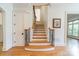 Entryway with wooden staircase featuring iron railings and hardwood floors, leading to the upper level at 7138 Wessynton Dr, Charlotte, NC 28226