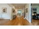 Bright foyer featuring hardwood floors, art and staircase leading to upper level at 7138 Wessynton Dr, Charlotte, NC 28226