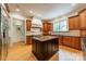 Well-appointed kitchen with custom cabinets, an island with counter seating, and views to the backyard through a window at 7138 Wessynton Dr, Charlotte, NC 28226