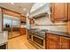 Modern kitchen with stainless steel appliances, custom cabinets, stone countertops, and hardwood floors for a sleek, updated design at 7138 Wessynton Dr, Charlotte, NC 28226