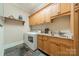 Functional laundry room with washer, dryer, sink, and cabinet storage at 7138 Wessynton Dr, Charlotte, NC 28226