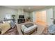 Comfortable living room with a large sectional, entertainment center, and stylish decor at 7138 Wessynton Dr, Charlotte, NC 28226