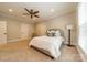 Spacious bedroom featuring neutral carpet, white walls, ceiling fan, and decorative pillows at 7138 Wessynton Dr, Charlotte, NC 28226