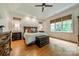 Bright main bedroom features tray ceilings, wood floors, with a chest and dresser for storage at 7138 Wessynton Dr, Charlotte, NC 28226