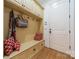 Charming mudroom with built-in bench, storage drawers, and overhead cabinets at 7138 Wessynton Dr, Charlotte, NC 28226
