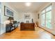 Well-lit office space with a large wooden desk, hardwood floors, and ample natural light from a large window at 7138 Wessynton Dr, Charlotte, NC 28226