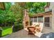 Outdoor patio with a brick fireplace and comfortable seating, perfect for entertaining at 7138 Wessynton Dr, Charlotte, NC 28226