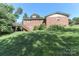 Spacious backyard with a wooden deck, stairs, and ample greenery at 805 Waverly Pl # 16, Statesville, NC 28677