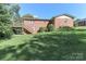 Lush green backyard featuring a deck, stairs, and plenty of space for outdoor activities at 805 Waverly Pl # 16, Statesville, NC 28677