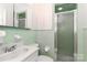 Clean, bright bathroom with green tile, a shower stall, and classic design at 805 Waverly Pl # 16, Statesville, NC 28677