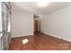 Bedroom featuring hardwood floors, neutral walls, and classic patterned curtains at 805 Waverly Pl # 16, Statesville, NC 28677