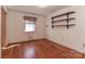 Bedroom with hardwood floors, floating shelves, and natural light through a single window at 805 Waverly Pl # 16, Statesville, NC 28677