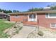 Inviting front of a brick home with a rock garden and covered porch to welcome guests at 805 Waverly Pl # 16, Statesville, NC 28677