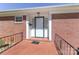 Close up of front porch showing the white door, brick, and black wrought iron at 805 Waverly Pl # 16, Statesville, NC 28677