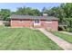 Charming brick home with a well-manicured lawn, walkway, and covered parking on a sunny day at 805 Waverly Pl # 16, Statesville, NC 28677