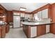 Bright kitchen features tile floor, white cabinets, appliances and wood paneling at 805 Waverly Pl # 16, Statesville, NC 28677