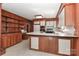 Open kitchen with white cabinets and appliances plus wood-paneled walls at 805 Waverly Pl # 16, Statesville, NC 28677