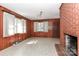 Bright living room with brick fireplace, natural light, and wood paneling at 805 Waverly Pl # 16, Statesville, NC 28677