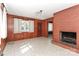Living room with brick fireplace, light colored flooring, and entry to another room at 805 Waverly Pl # 16, Statesville, NC 28677