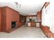 Open living room and kitchen area with brick fireplace and wood paneling at 805 Waverly Pl # 16, Statesville, NC 28677