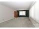 Bright living room with large windows and neutral carpet provides a comfortable space for relaxation at 805 Waverly Pl # 16, Statesville, NC 28677