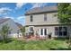 A backyard features a patio, fire pit, and a lush green lawn for outdoor entertaining and relaxation at 815 Clearbrook Rd, Matthews, NC 28105