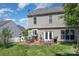 A backyard features a patio, fire pit, and a lush green lawn for outdoor entertaining and relaxation at 815 Clearbrook Rd, Matthews, NC 28105