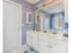 Bathroom featuring double sinks with a large mirror, and white cabinets at 815 Clearbrook Rd, Matthews, NC 28105