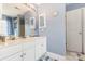 Bathroom featuring double sinks with a large mirror, and white cabinets at 815 Clearbrook Rd, Matthews, NC 28105
