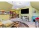 A bonus room with an accent rug, with shelves and entertainment center at 815 Clearbrook Rd, Matthews, NC 28105
