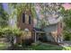 Charming two-story home featuring a brick facade, black shutters, and a well-maintained landscaped front yard at 815 Clearbrook Rd, Matthews, NC 28105