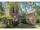 Charming two-story home featuring a brick facade, black shutters, and a well-maintained landscaped front yard at 815 Clearbrook Rd, Matthews, NC 28105