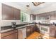 Well-equipped kitchen featuring stainless steel appliances, granite countertops, and dark wood cabinets at 815 Clearbrook Rd, Matthews, NC 28105