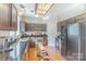 Modern kitchen equipped with stainless steel appliances, dark wood cabinets, and durable granite countertops at 815 Clearbrook Rd, Matthews, NC 28105